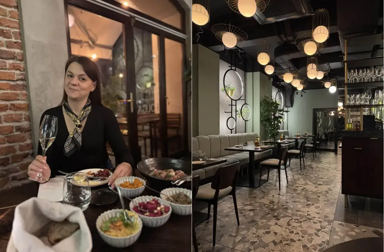 Kobieta z kieliszkiem wina w jednej z top 10 restauracji w Krakowie. Wnętrze lokalu z nowoczesnym designem i eleganckimi lampami.