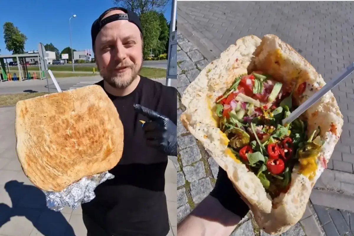 Mężczyzna prezentuje gigantycznego kebaba, który może być najdroższym kebabem w Polsce. W środku świeże warzywa i pikantne dodatki.